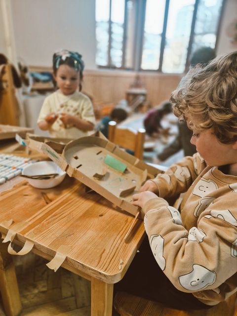 A long table of small artists