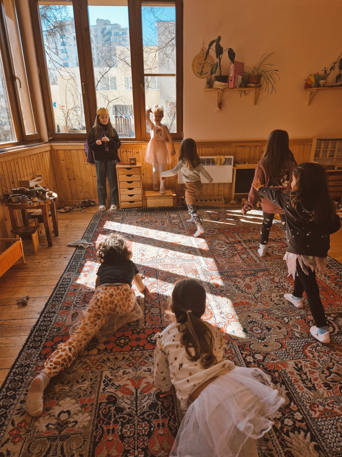 Children running in a sunlit workshop hall